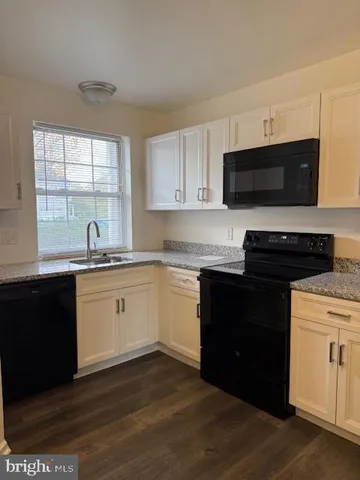a kitchen with a sink and a window