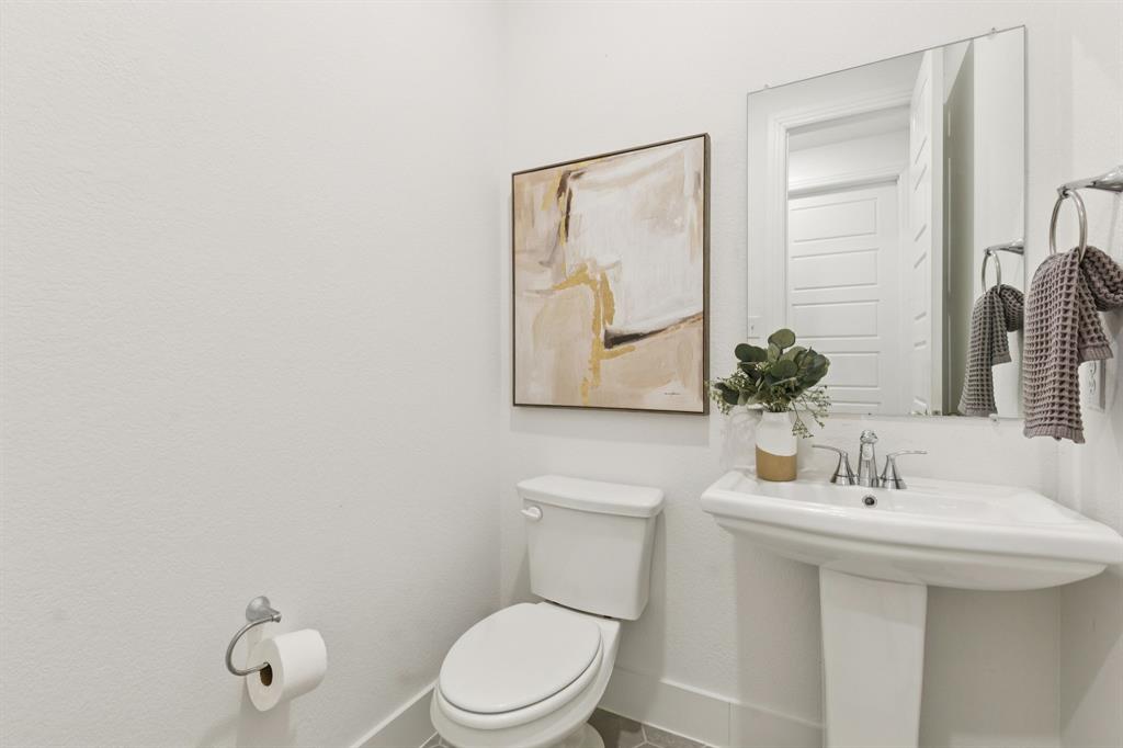 1903 Midhurst Drive Forney, TX 75126 - Photo 12 of 31 a bathroom with a toilet sink and mirror