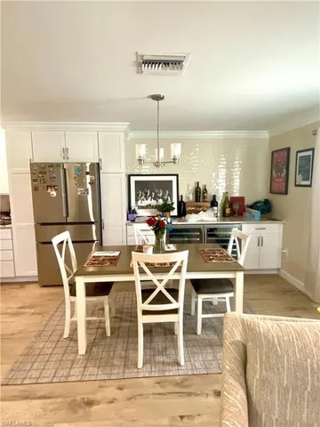 a dining room with furniture and wooden floor
