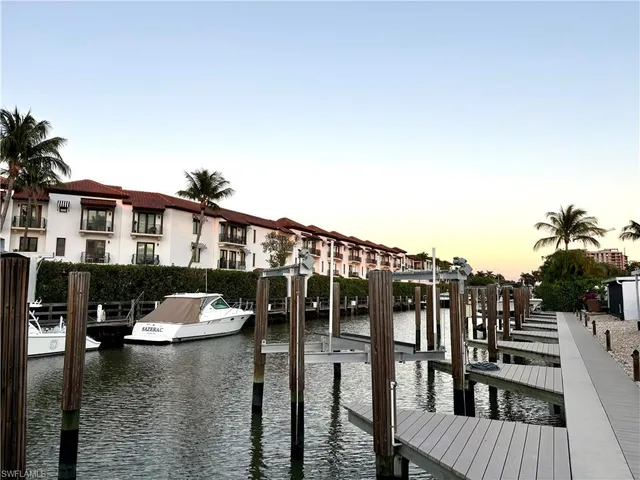 a view of a lake with boats and trees in the background