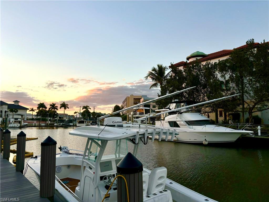 1435 Curlew Avenue, Unit 1 Naples, FL 34102 - Photo 14 of 19 a view of a lake with boats and trees in the background