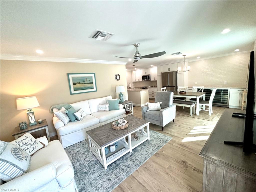 1435 Curlew Avenue, Unit 1 Naples, FL 34102 - Photo 19 of 19 a living room with lots of furniture and view of kitchen