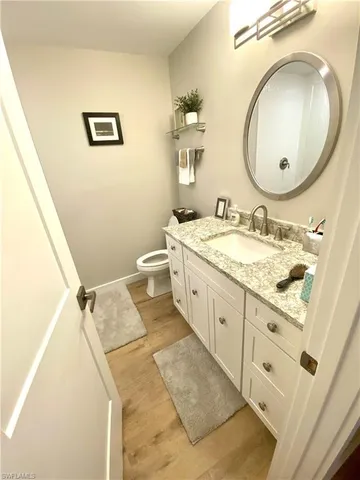 a spacious bathroom with a granite countertop sink and a mirror