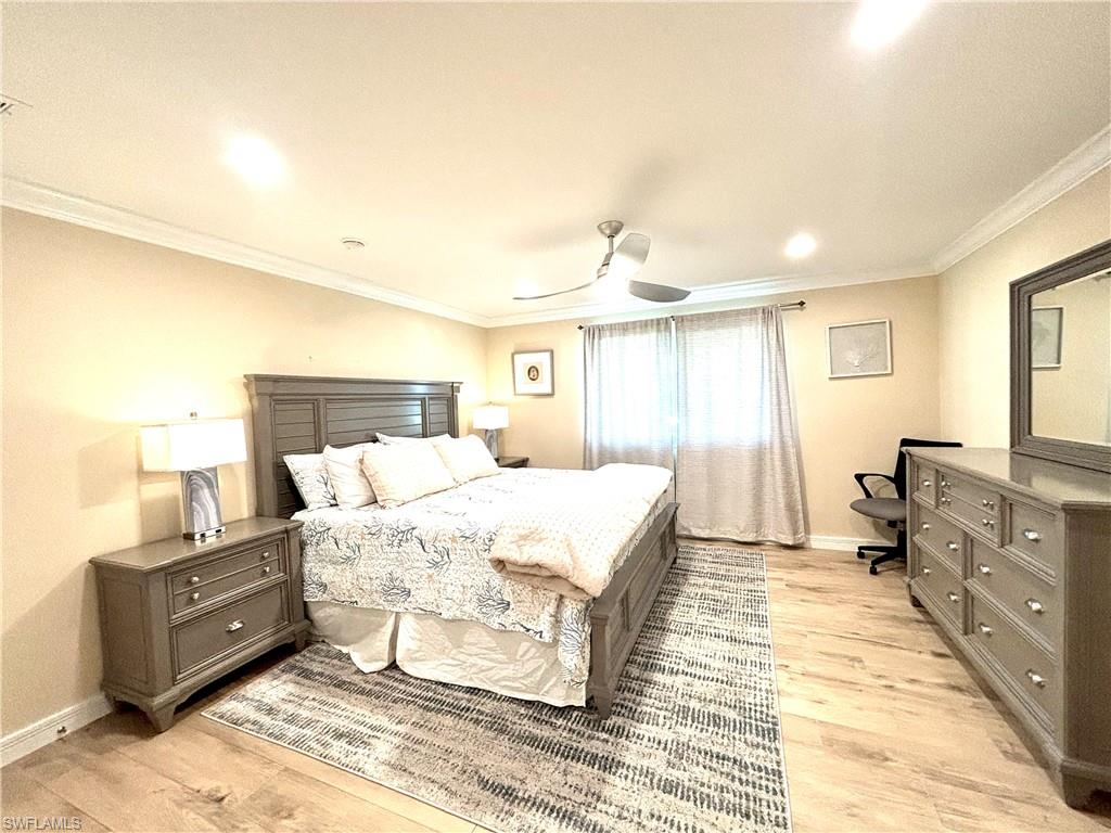 1435 Curlew Avenue, Unit 1 Naples, FL 34102 - Photo 4 of 19 a bed room with a bed and a night stand