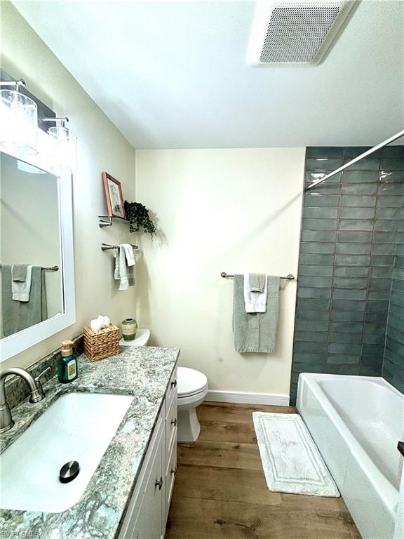 1435 Curlew Avenue, Unit 1 Naples, FL 34102 - Photo 8 of 19 a bathroom with a granite countertop sink and a mirror