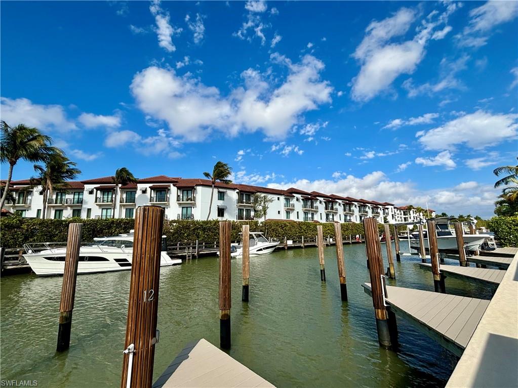 1435 Curlew Avenue, Unit 1 Naples, FL 34102 - Photo 9 of 19 a view of a lake with a house