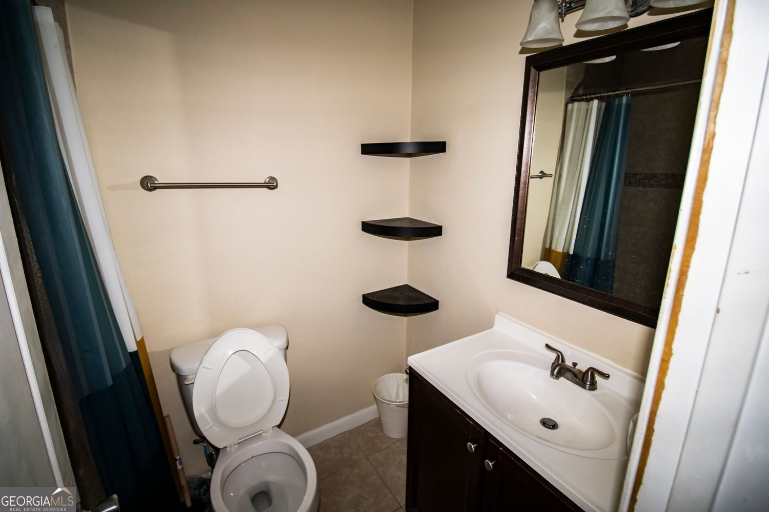 2805 Northeast Expressway Northeast, Unit C11 Atlanta, GA 30329 - Photo 13 of 14 a bathroom with a sink a toilet and mirror