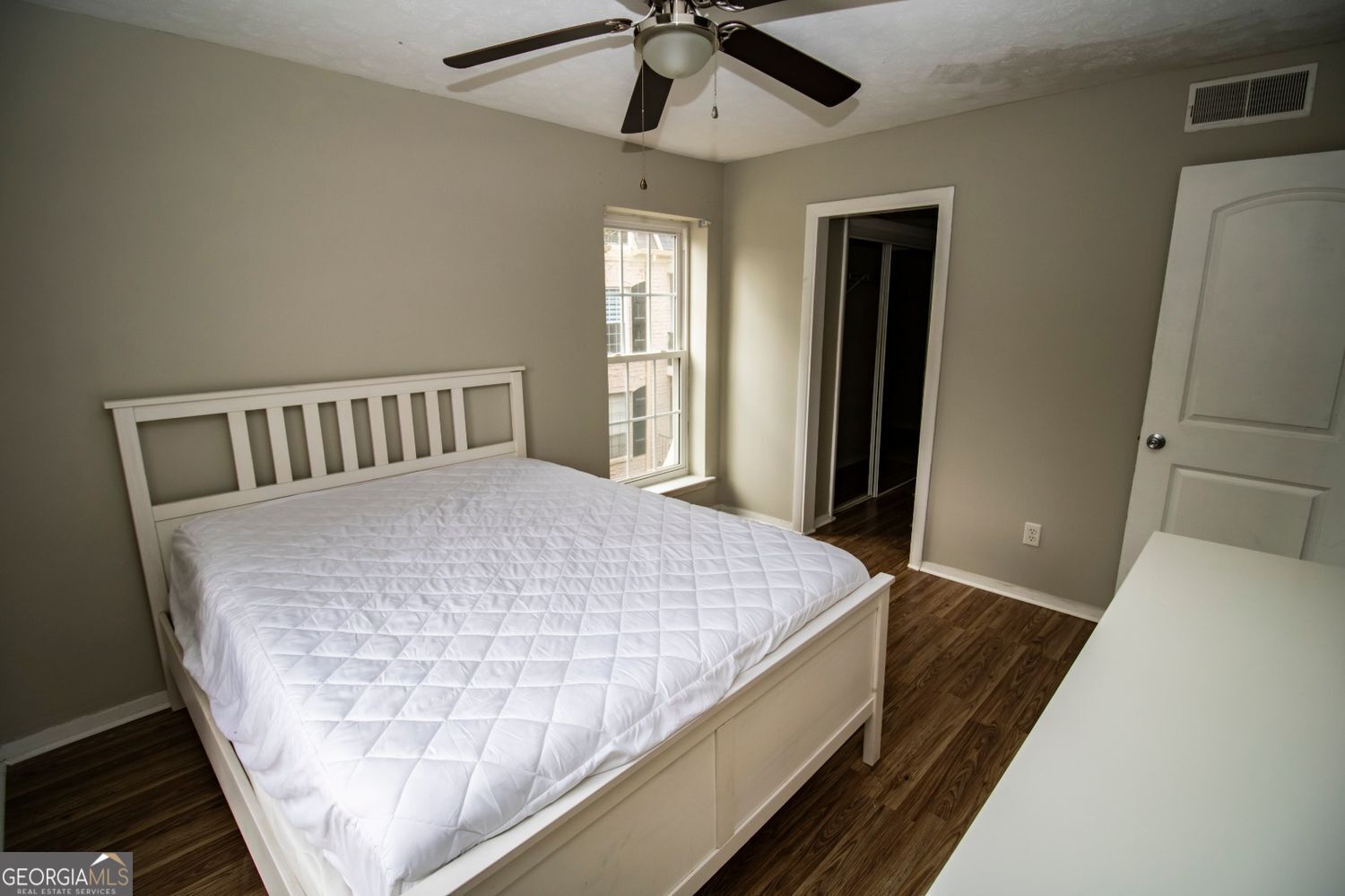 2805 Northeast Expressway Northeast, Unit C11 Atlanta, GA 30329 - Photo 2 of 14 a bed sitting in a bedroom next to a window