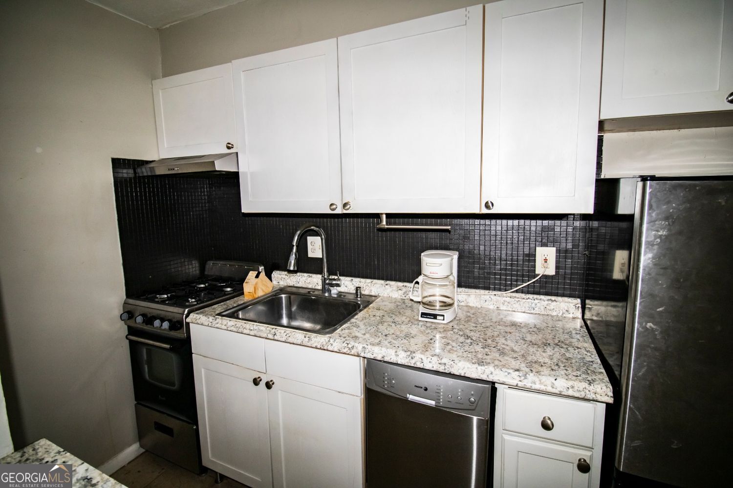 2805 Northeast Expressway Northeast, Unit C11 Atlanta, GA 30329 - Photo 8 of 14 a kitchen with a sink a stove and cabinets