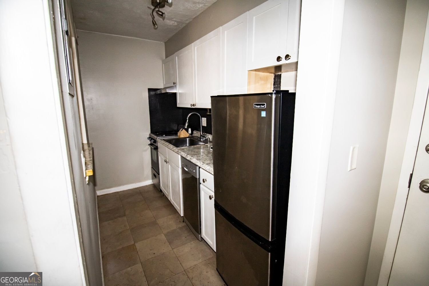 2805 Northeast Expressway Northeast, Unit C11 Atlanta, GA 30329 - Photo 9 of 14 a kitchen with refrigerator a microwave a sink and dishwasher