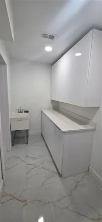 a view of an empty room with a fireplace and a window