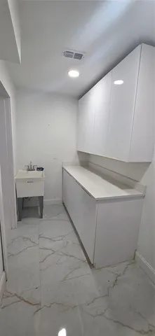 a view of an empty room with a fireplace and a window