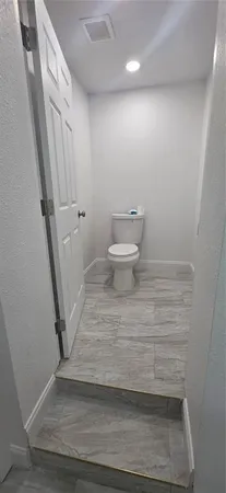 a room with wooden floor and stairs