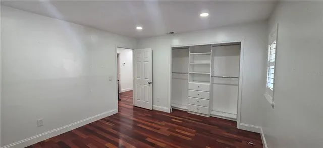 a view of a backyard with a fountain plants and large tree