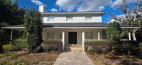 a view of a porch with a table and chairs