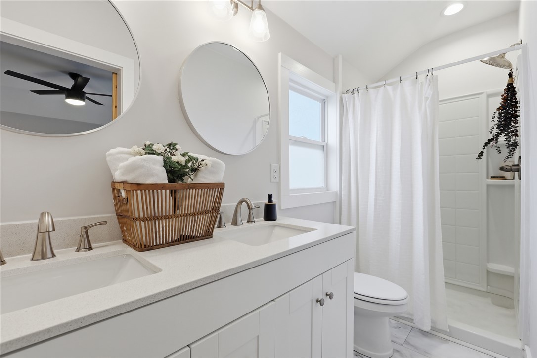 1 Brock Street Pelzer, SC 29669 - Photo 16 of 25 Double vanity with clean lines and modern fixtures complement this bright, naturally lit bathroom.