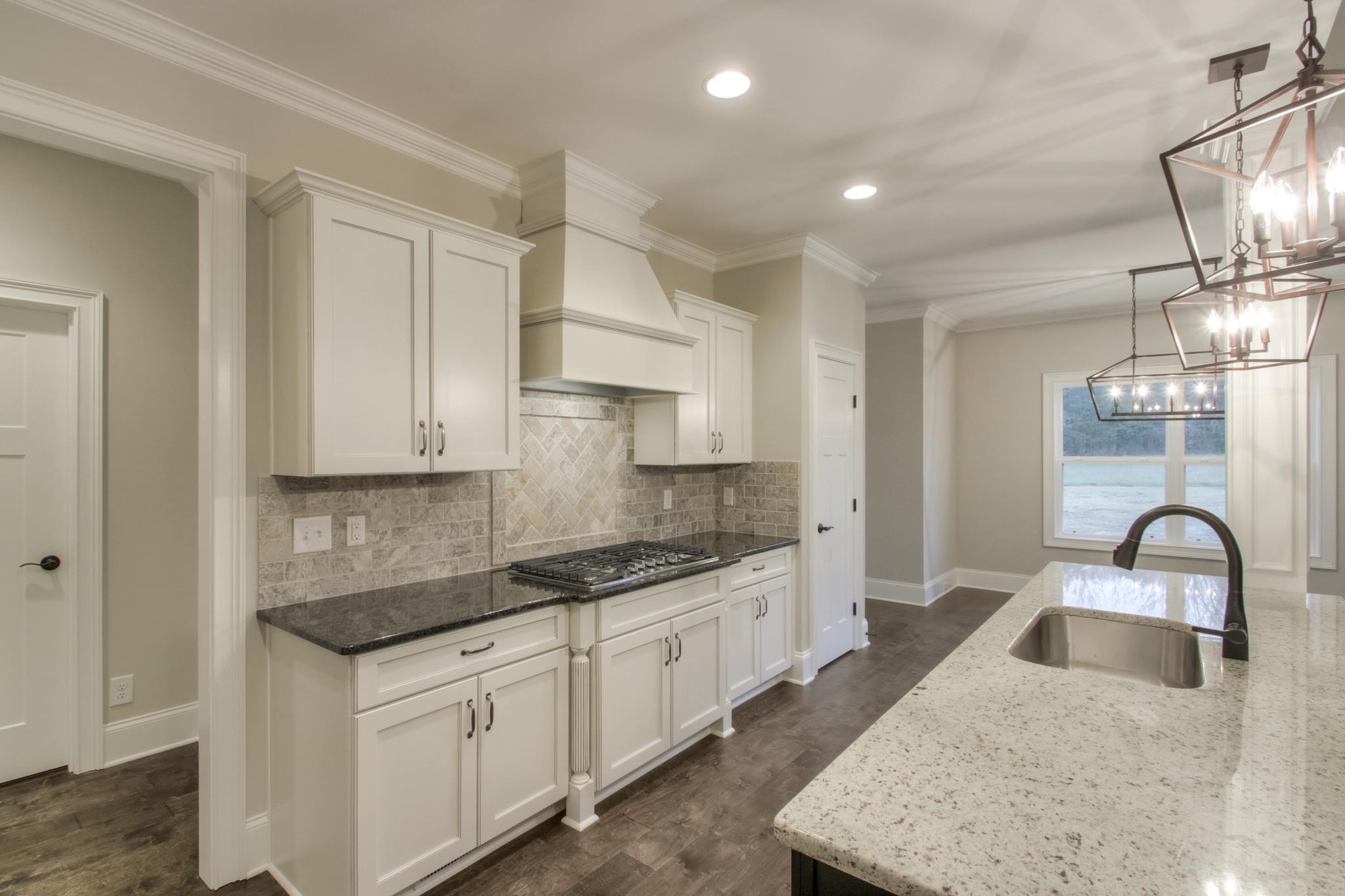 2261 Cairo Bend Road Lebanon, TN 37087 - Photo 8 of 30 a kitchen with granite countertop a sink a stove and cabinets