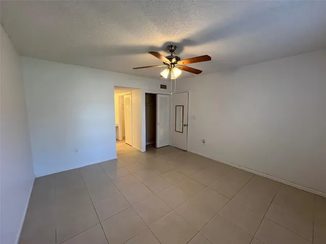 a view of a livingroom with a ceiling fan and window