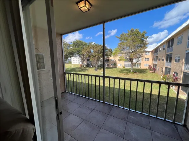 a view of a livingroom with a ceiling fan and window
