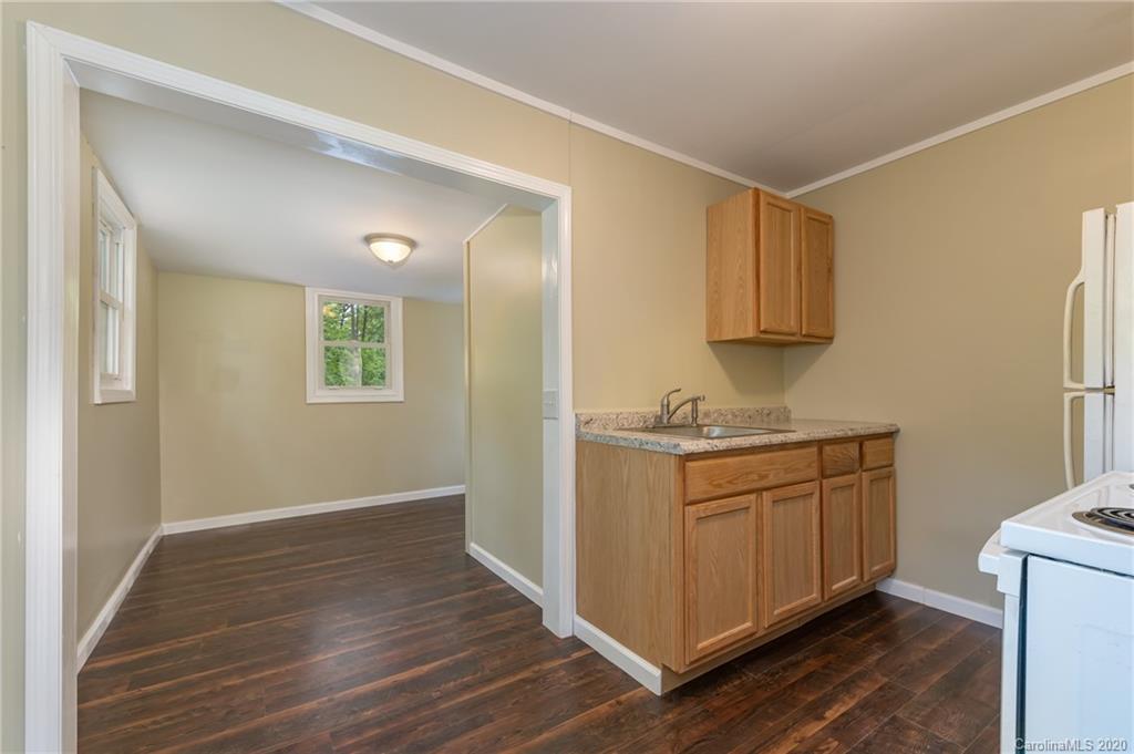360 East 2nd Street Rutherfordton, NC 28139 - Photo 11 of 19 a kitchen with granite countertop a sink cabinets and wooden floor