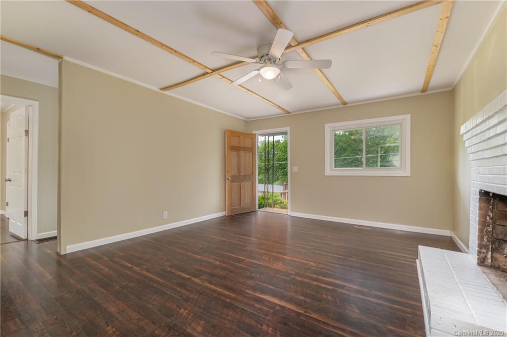 360 East 2nd Street Rutherfordton, NC 28139 - Photo 12 of 19 an empty room with wooden floor fan and windows