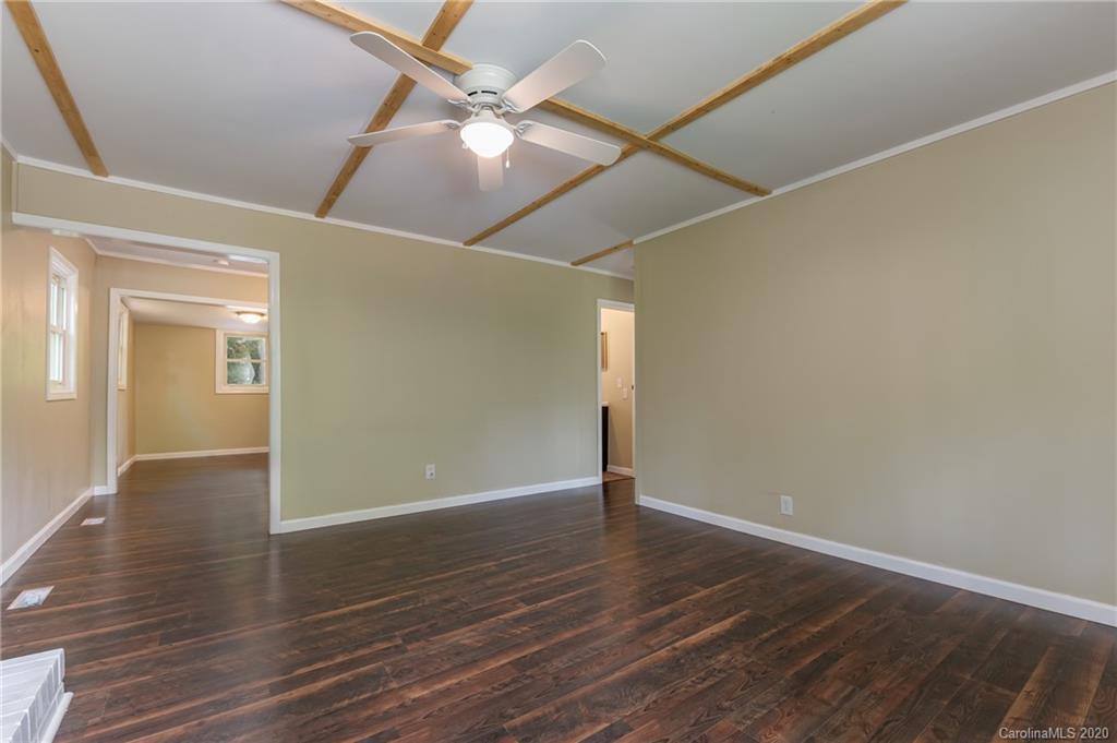 360 East 2nd Street Rutherfordton, NC 28139 - Photo 14 of 19 an empty room with wooden floor fan and windows