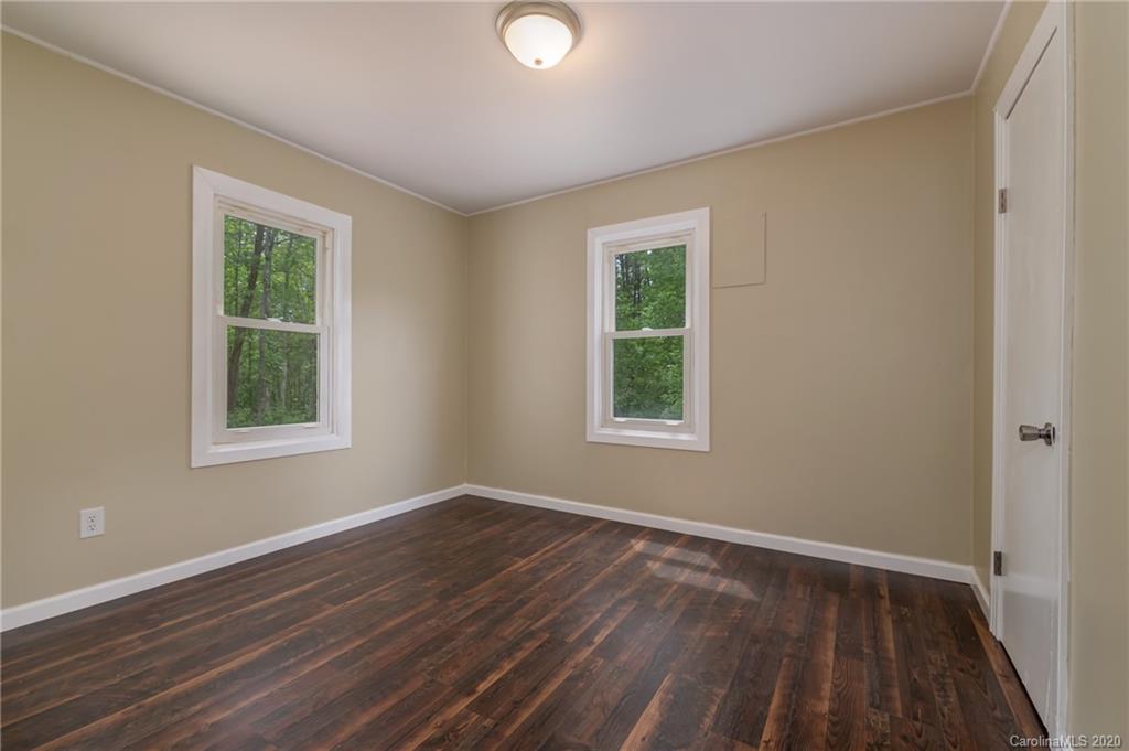 360 East 2nd Street Rutherfordton, NC 28139 - Photo 16 of 19 a view of an empty room with wooden floor and a window