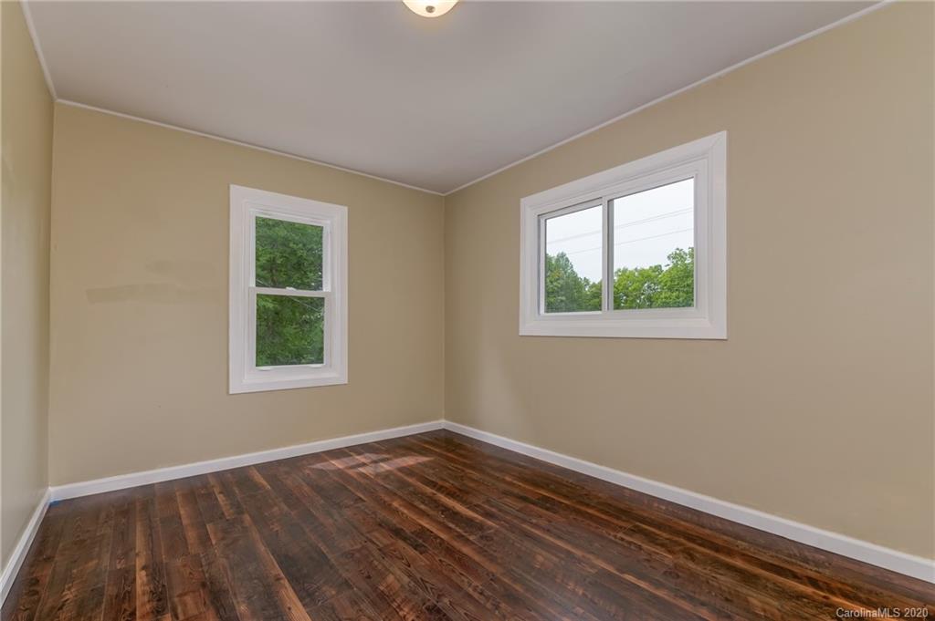 360 East 2nd Street Rutherfordton, NC 28139 - Photo 18 of 19 an empty room with wooden floor and windows