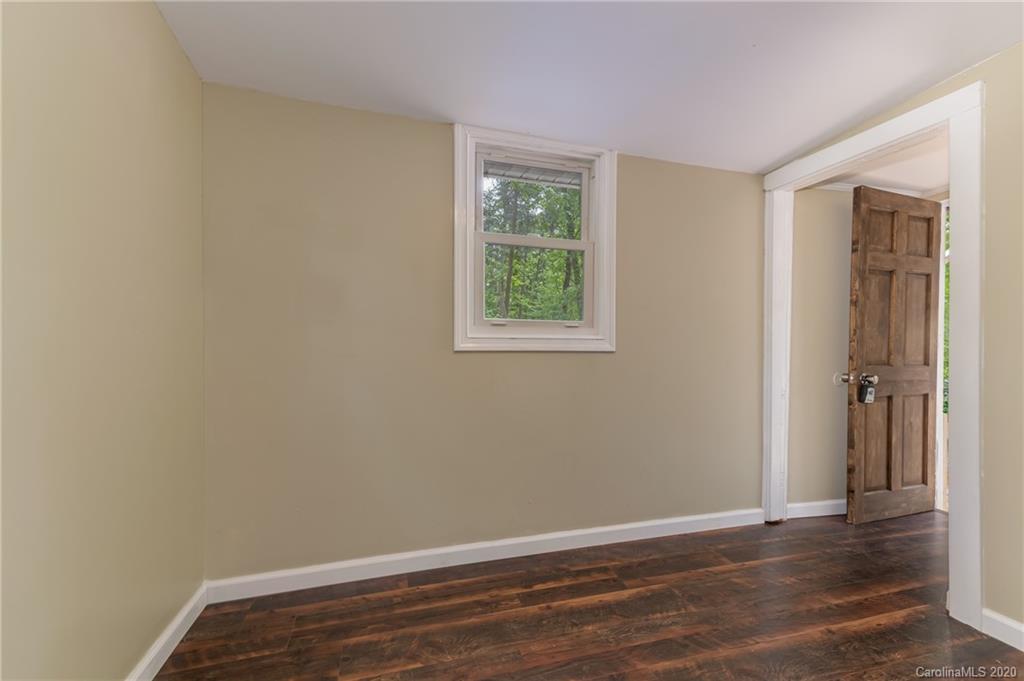 360 East 2nd Street Rutherfordton, NC 28139 - Photo 8 of 19 an empty room with wooden floor and windows