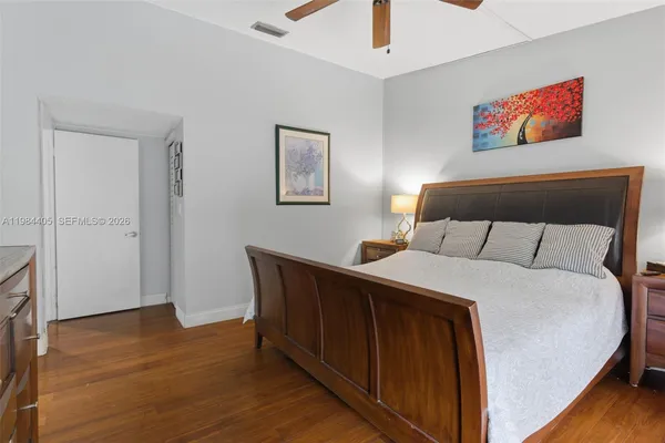 a bedroom with a bed and a painting on the wall