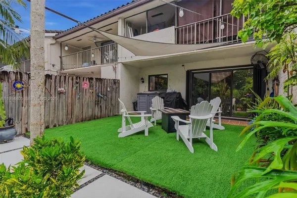 a view of a house with backyard porch and sitting area