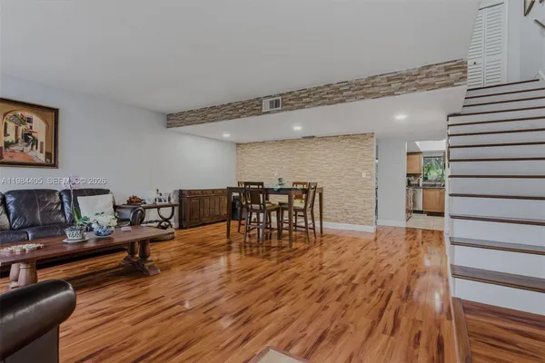 a living room with furniture and wooden floor
