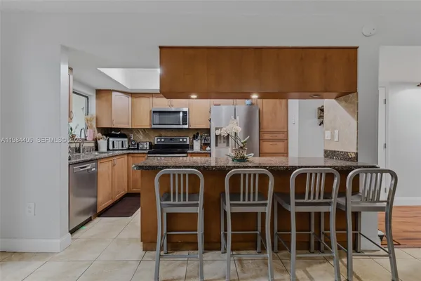 a kitchen with stainless steel appliances a stove a sink and a refrigerator