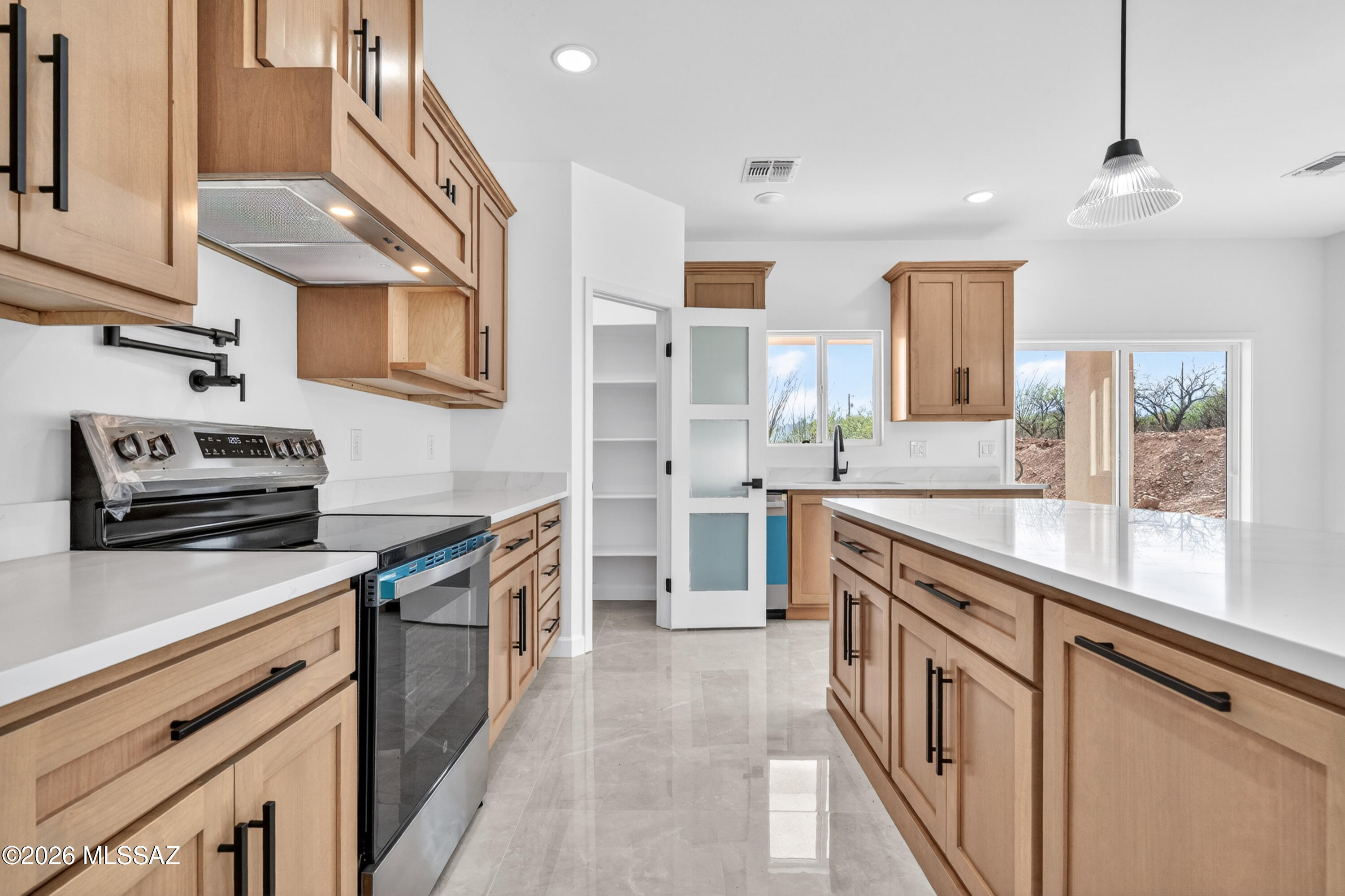 1834 Circulo Glorieta Rio Rico, AZ 85648 - Photo 14 of 35 a kitchen with stainless steel appliances granite countertop a sink stove and cabinets