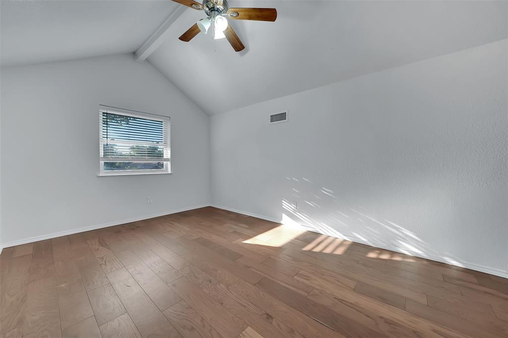 1024 East Peters Colony Road Carrollton, TX 75007 - Photo 29 of 38 Unfurnished room with beamed ceiling, wood-type flooring, and ceiling fan