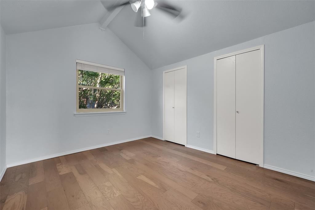 1024 East Peters Colony Road Carrollton, TX 75007 - Photo 32 of 38 Unfurnished bedroom featuring multiple closets, light wood finished floors, beam ceiling, and ceiling fan