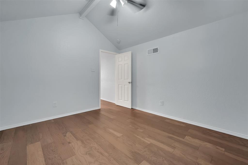 1024 East Peters Colony Road Carrollton, TX 75007 - Photo 33 of 38 Unfurnished room featuring beamed ceiling, wood finished floors, and ceiling fan
