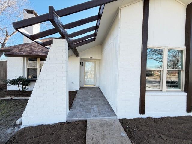 1024 East Peters Colony Road Carrollton, TX 75007 - Photo 34 of 38 View of exterior entry with brick siding