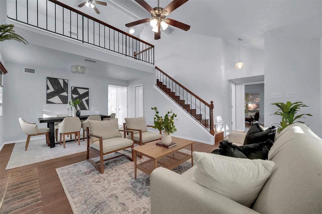 1024 East Peters Colony Road Carrollton, TX 75007 - Photo 8 of 38 Living area with a ceiling fan, dark wood-style flooring, and a high ceiling