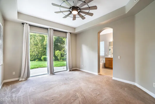 an empty room with windows and outdoor view
