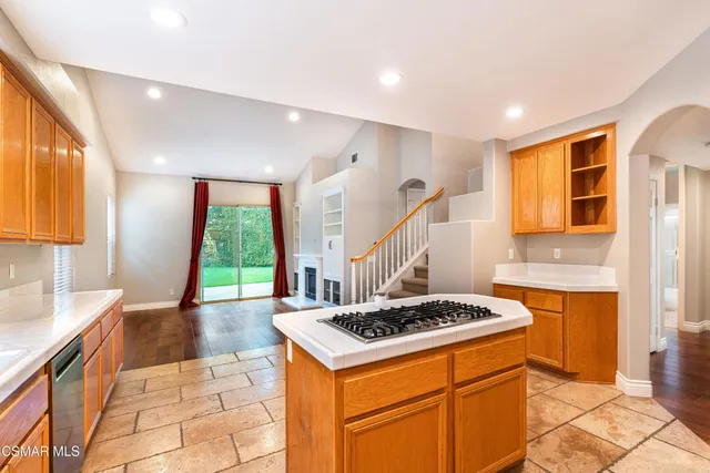a kitchen with a stove a sink and a refrigerator