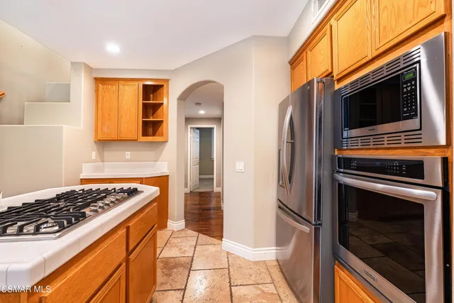 a kitchen with stainless steel appliances granite countertop a stove and a refrigerator