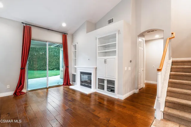 a view of an entryway with wooden floor and door