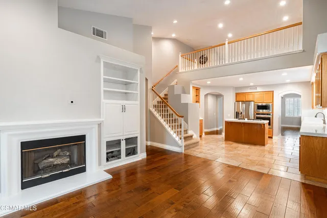 a living room with wooden floors and a fireplace