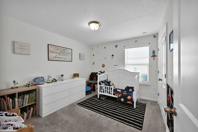 a bedroom with furniture and a book shelf