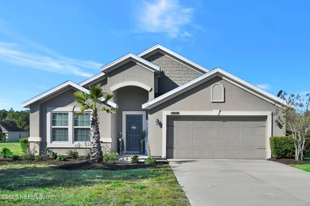 a front view of a house with a yard and garage