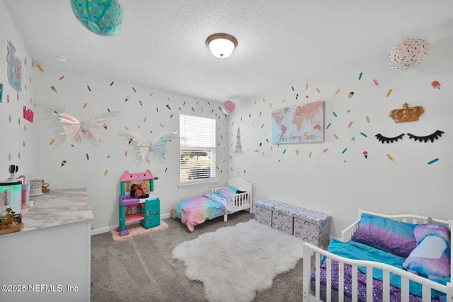 a bedroom with furniture and a window