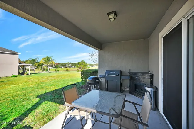 a view of a porch with furniture and a yard
