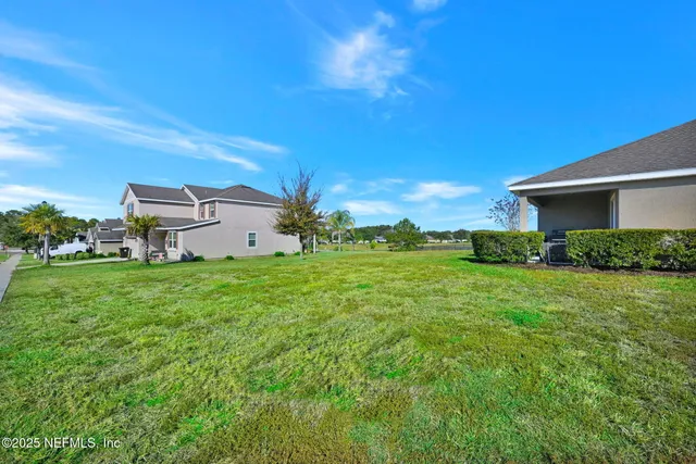 a backyard of a house with lots of green space