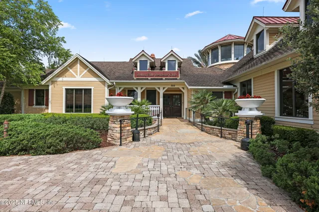 a front view of a house with a garden and plants